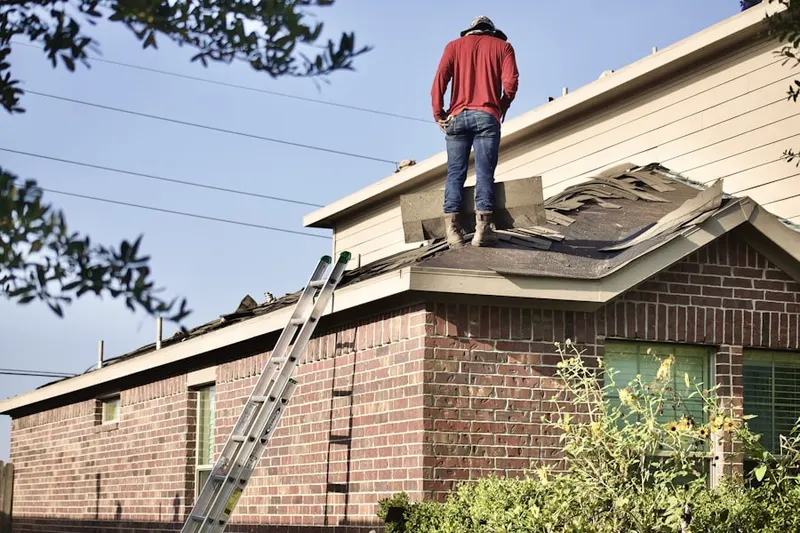 Professional roofer working on a residential roof in Rushwood